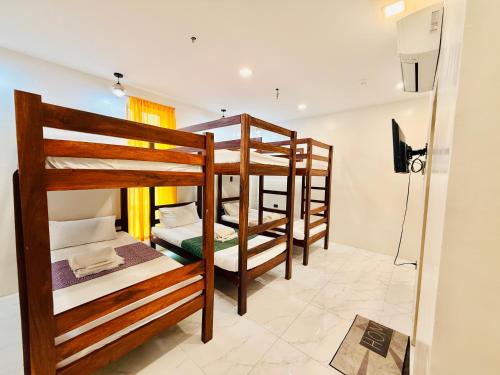 a group of bunk beds in a room at Casa Ysabel Transient Inn in Ayusan Norte
