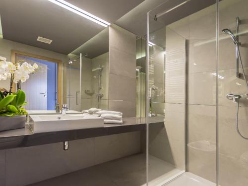 W łazience znajduje się umywalka i przeszklony prysznic. w obiekcie VacationClub - Diune Apartment 502A w Kołobrzegu