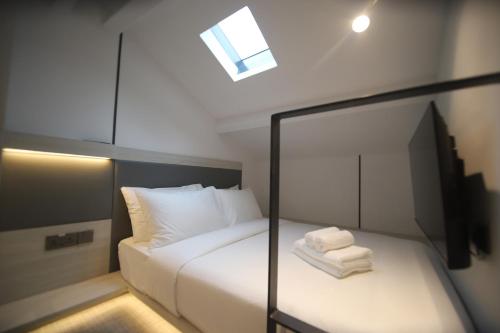 a bedroom with a bed with towels on it at Heritage Collection on KG - Mobile App Check-In in Singapore