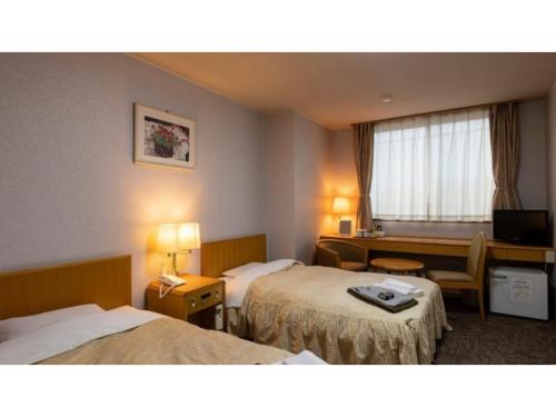 a hotel room with two beds and a desk at Hotel Symphony - Vacation STAY 85390v in Sagae
