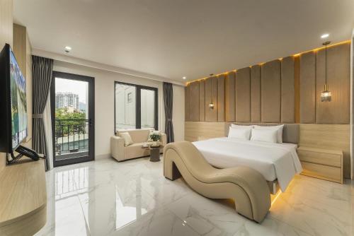 a bedroom with a large white bed and a tv at A89 West Lake Hotel in Hanoi