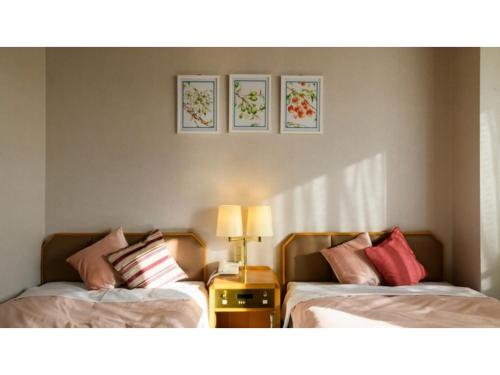 two beds sitting next to each other in a room at Hotel Symphony - Vacation STAY 37089v in Sagae