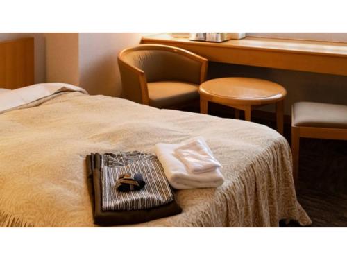 a hotel room with a bed with towels and a table at Hotel Symphony - Vacation STAY 37096v in Sagae