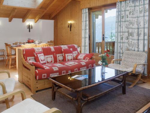 a living room with a red couch and a table at Apartment Baudrier A28 by Interhome in Verbier