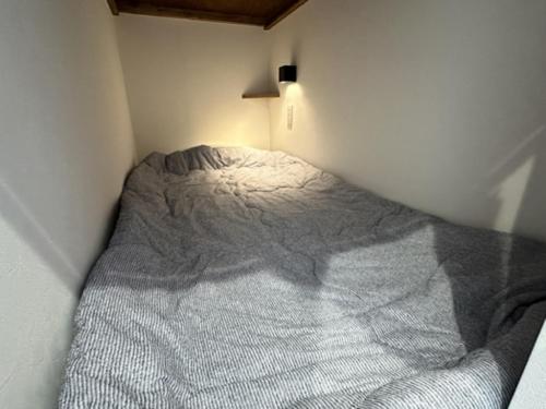 a bed in a corner of a room at Monarch Hotel - Vacation STAY 42994v in Otaru