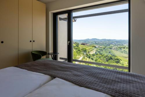 a bedroom with a bed and a large window at Persolis luxury sun residence in Kojsko