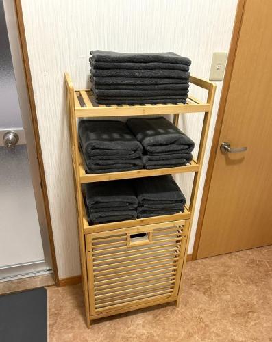 a wooden rack with black towels on a door at Sakae - Vacation STAY 41407v in Goto