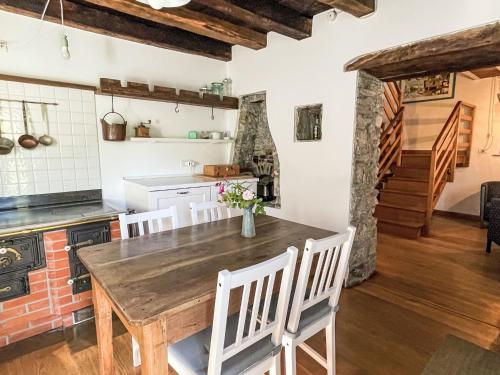 a kitchen with a wooden table and chairs at Holiday Home Casa Lienartova by Interhome in Grimacco