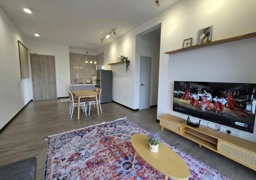 a living room with a large flat screen tv at MySky Putrajaya in Putrajaya