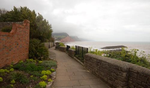 a walkway next to a brick wall next to the ocean at The Globe in Exeter