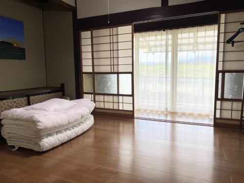 a bedroom with a white bed in a room with windows at 8co - Vacation STAY 69979v in Chino