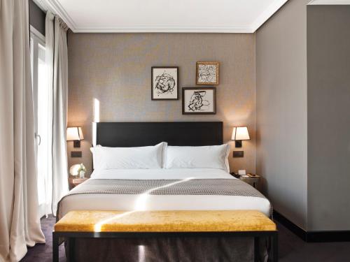 a bedroom with a large bed and a window at The Principal Madrid, Small Luxury Hotels in Madrid