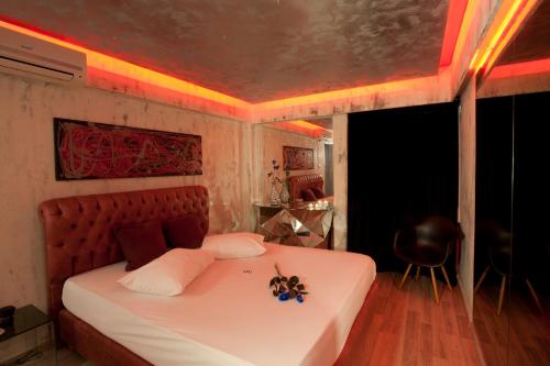 a bedroom with a white bed with flowers on it at The Crystal Blue Hotel in Athens