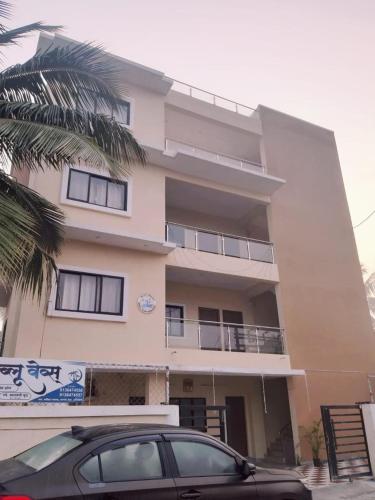 a building with a car parked in front of it at Beach Walk - By Blue waves in Alībāg