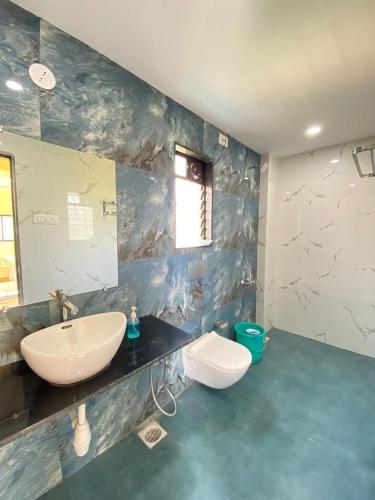 a bathroom with a sink and a mirror at Beach Walk - By Blue waves in Alībāg