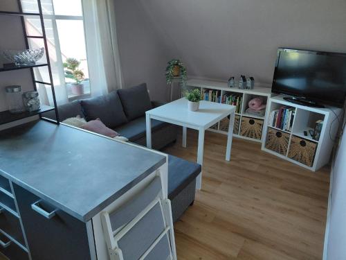 a living room with a couch and a table at Ferienwohnung Margarethe in Stedesdorf