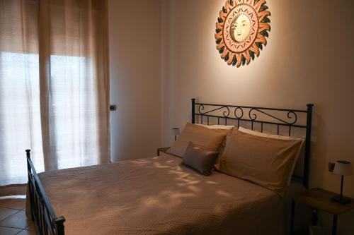 a bedroom with a bed with a clock on the wall at Il Sogno di Ilaria in Arezzo