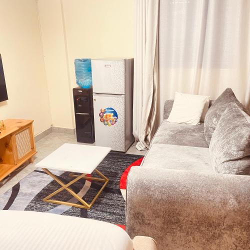 a living room with a couch and a refrigerator at Studio apartment in Ruka in Ruaka