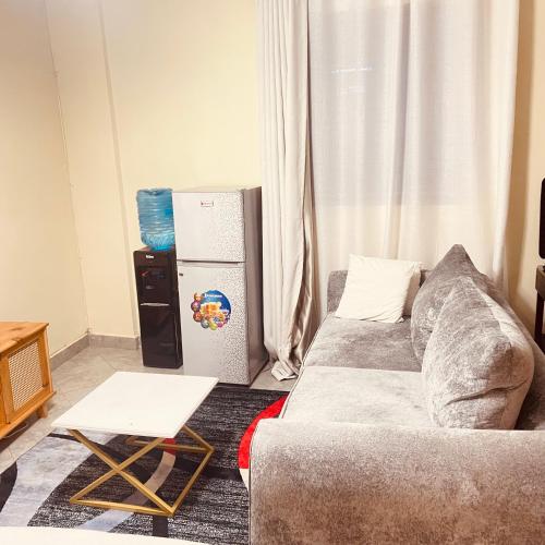 a living room with a couch and a refrigerator at Studio apartment in Ruka in Ruaka