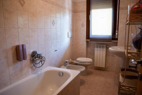 a bathroom with a tub and a toilet and a sink at Il Sogno di Ilaria in Arezzo