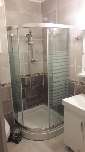 a shower with a glass door in a bathroom at Süreyya Hanım Otel in İzmir