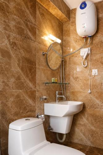 a bathroom with a toilet and a sink at Apartment Hotel 11 Thamel in Kathmandu