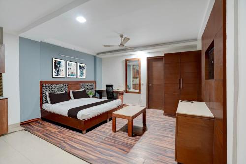 a bedroom with a bed and a desk and a tv at Townhouse Millenium City Centre in Gurgaon