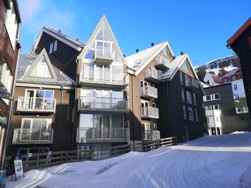 a group of buildings with snow on the ground at Dählie Åre Torg Apartments in Åre