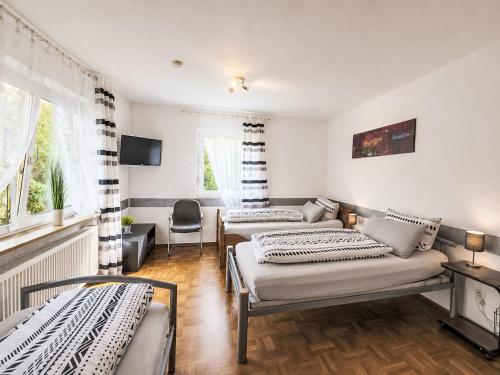 a room with three beds and a window at Apartment Wohnung „Sonnendeck“ by Interhome in Laupheim