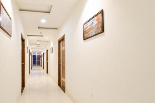a corridor of a hospital with paintings on the walls at Super Townhouse Raniganj Formerly Devi Residency in Hyderabad