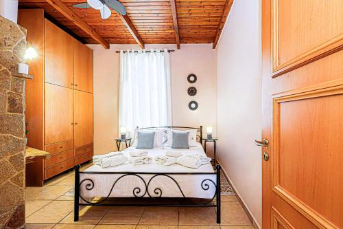 a bedroom with a bed in a room with a window at Villa Anthemida Chania in Ayiá