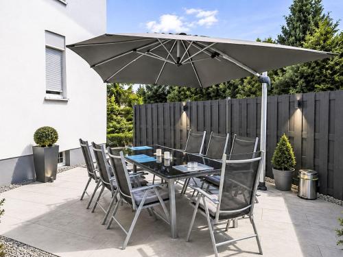 a table and chairs with an umbrella on a patio at Holiday Home Bailey by Interhome in Laupheim