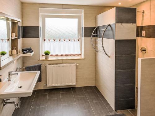 a bathroom with a sink and a shower at Apartment Wohnung Gartenblick by Interhome in Laupheim