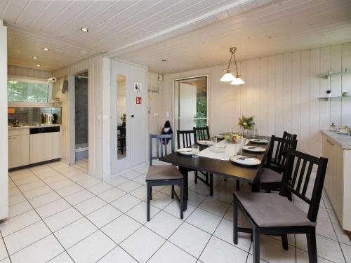 a kitchen and dining room with a table and chairs at Holiday Home Chalet Guldeli by Interhome in Kandergrund