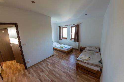 a small room with two beds and a window at Vinum Vivo winery in Nevidzany