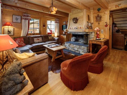 a living room with a couch and a fireplace at Chalet Dörfli by Interhome in Les Diablerets