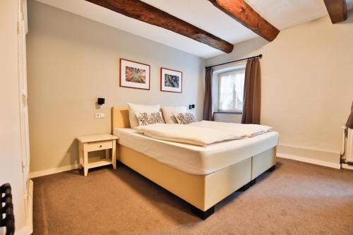 a bedroom with a bed and a window at Hotel Gut Funkenhof in Sundern