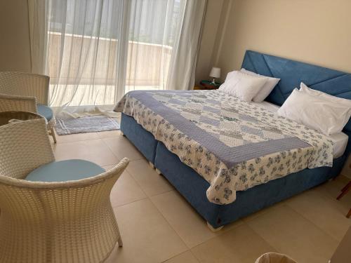 a bedroom with a bed and a chair and a window at Elgouna Hurghada egypt mangroovy in Hurghada
