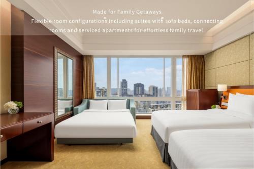 a hotel room with two beds and a window at Shangri-La Chengdu in Chengdu