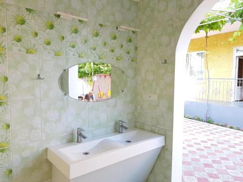 a bathroom with a sink and a mirror at Мини отель Семейного типа. in Zatoka
