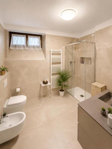 a bathroom with a toilet sink and a shower at Da Mara Lago Di Como in Sormano