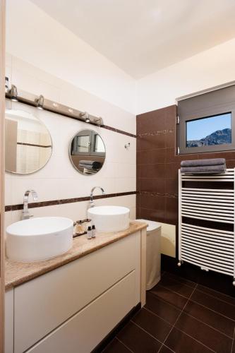 a bathroom with two sinks and a mirror at Lamon Villa in Plakias