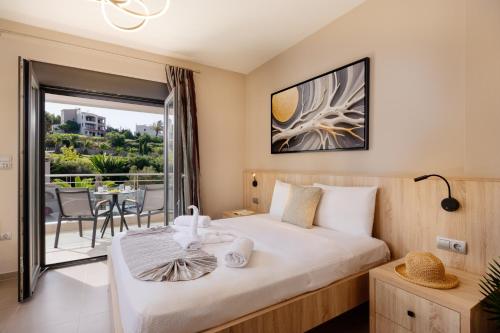 a hotel room with a bed and a balcony at Lamon Villa in Plakias