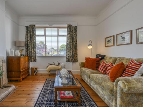 a living room with a couch and a table at Holiday Home Sullivan by Interhome in Drumnadrochit