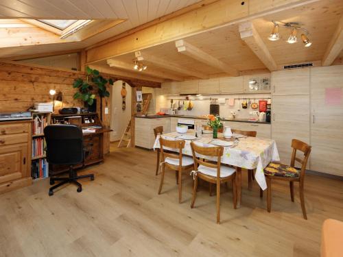 a kitchen and dining room with a table and chairs at Apartment Beim Thor Klein by Interhome in Brienzwiler