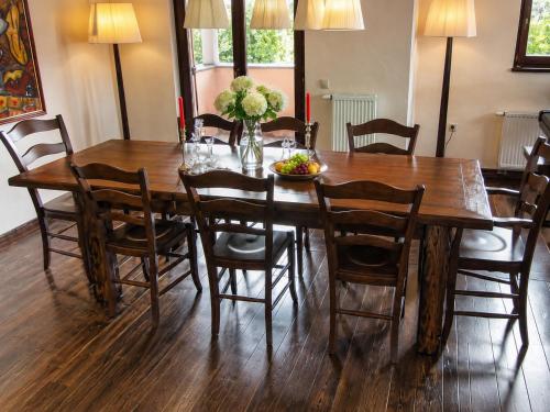 a dining room with a wooden table and chairs at Villa Noiram - Your dream Getaway in Nature in Senožeče