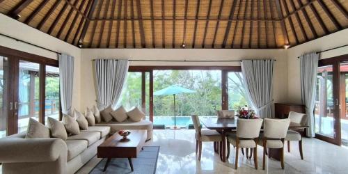 a living room with a couch and a table at Moksha Wellness Bali in Plaga