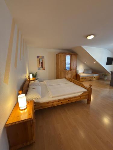 a large bedroom with a large bed in a attic at Pension & Ferienhof Glüß in Lünzen