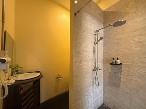 a bathroom with a shower and a sink at Inthira Thakhek in Thakhek