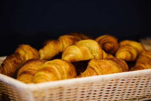 a basket filled with lots of croissants at Hotel Malcom and Barret in Valencia